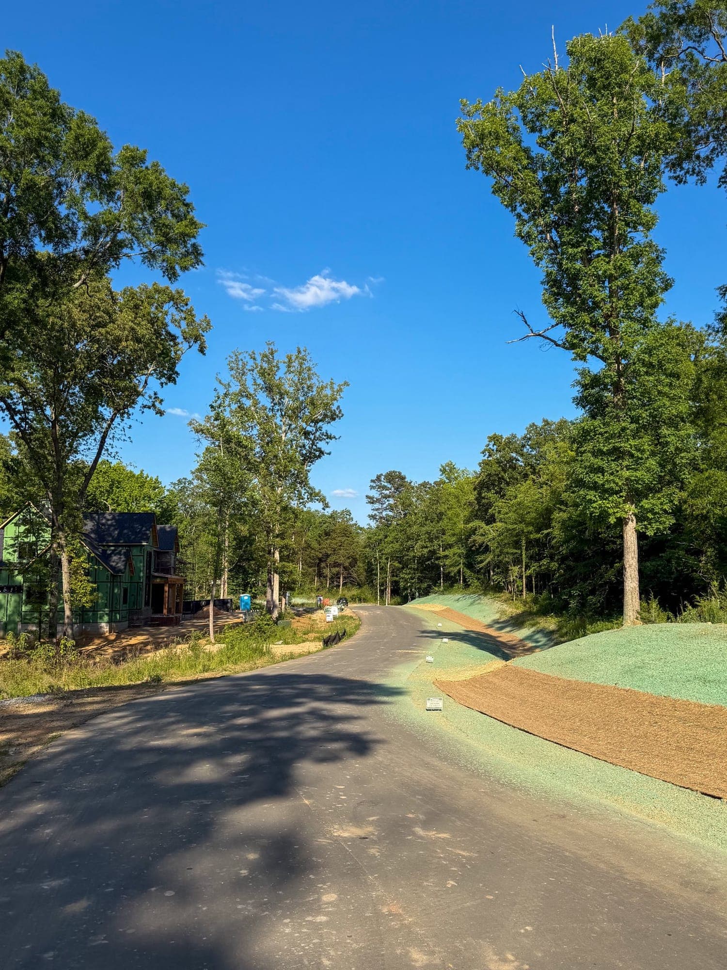 Erosion control blanket installed along a roadway slope near a new construction site