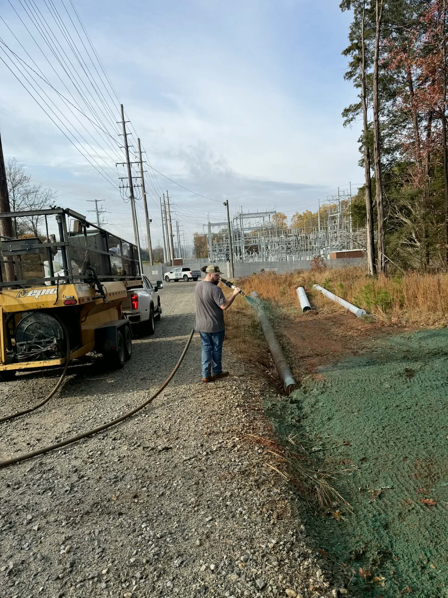 Prime Hydroseeding crew applying hydroseed and erosion control matting along a utility right-of-way